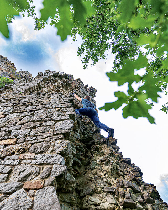 Free-solo climbing on a rock face, without a rope