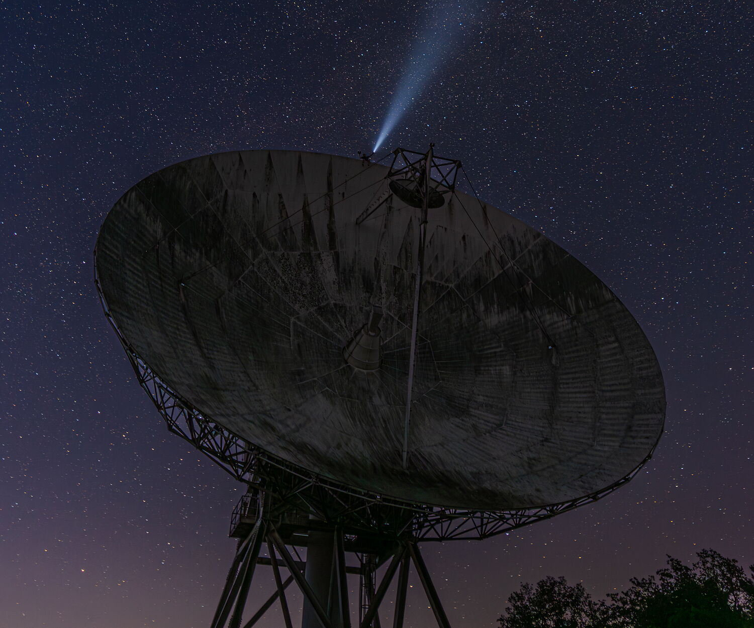 Parabolic antenna of the Lessive space telecommunications earth station, pointed at a starry night sky
